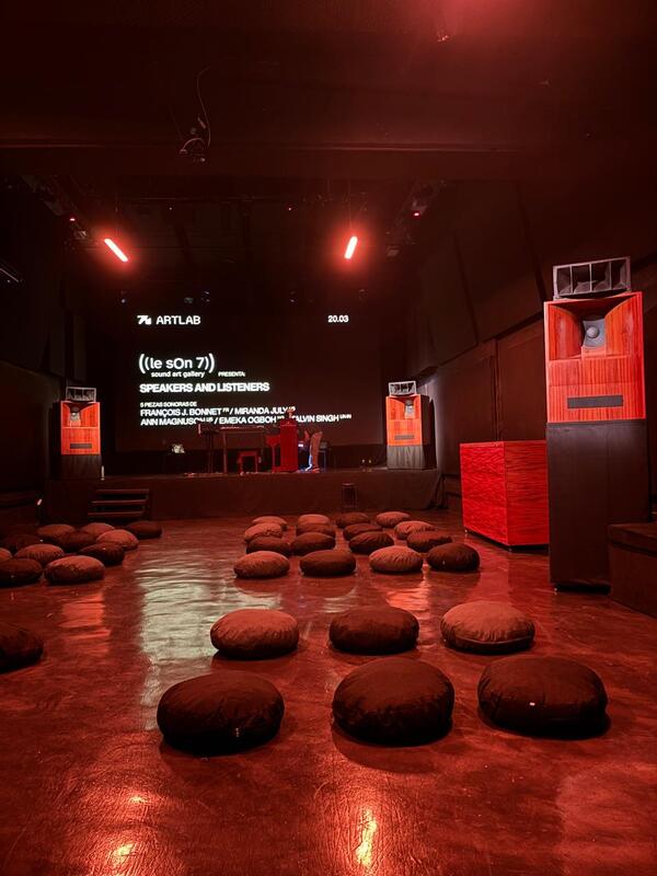 The hall before the public arrived, with three of four speakers pictured